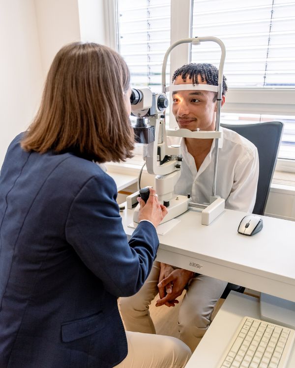 Zu sehen ist eine Optikerin bei einem Sehtest